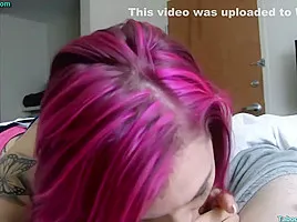 Tattooed milf with pink hair is giving a blowjob to her step- son just for fun
